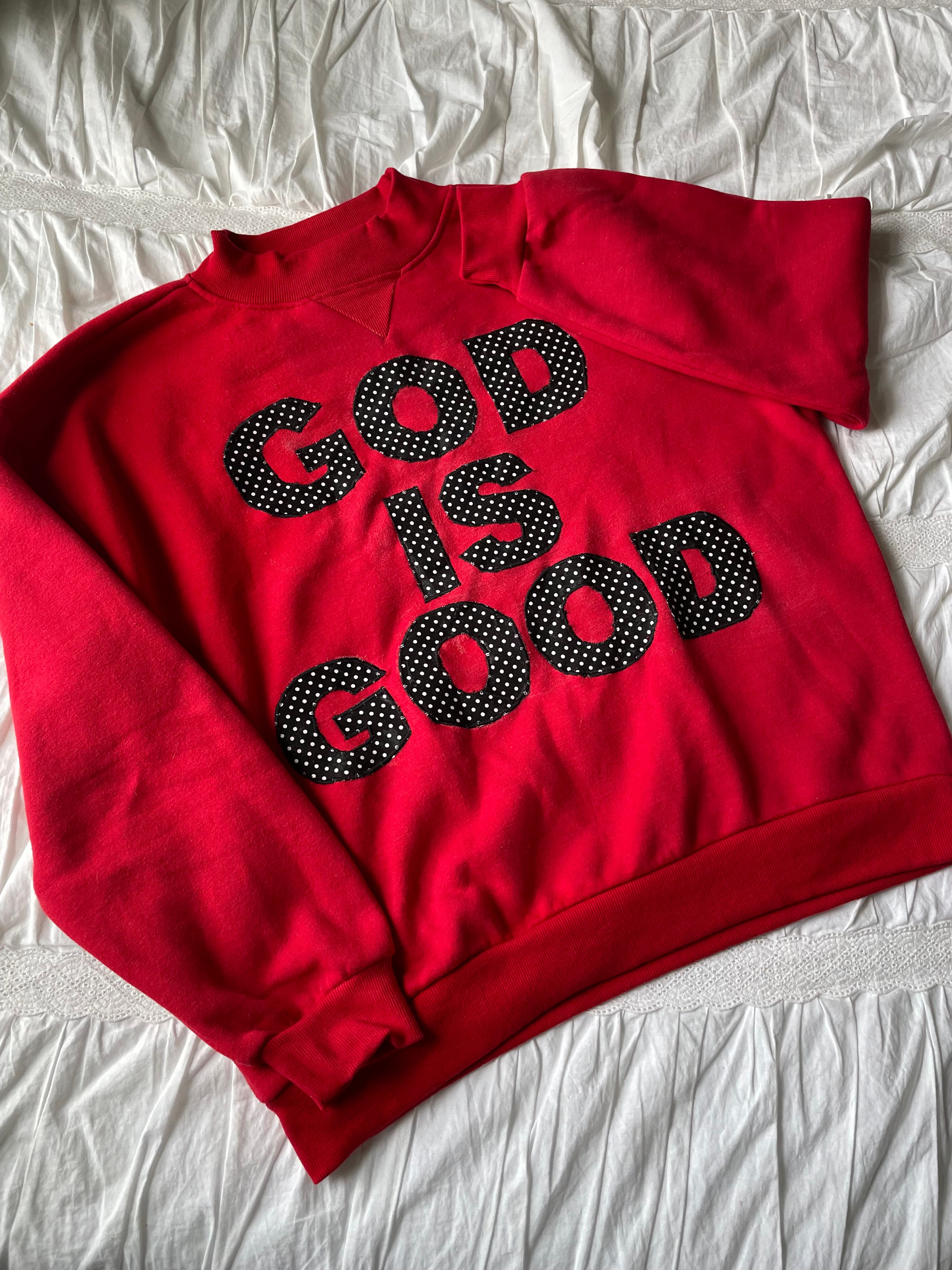 Red hoodie with God Is Good letters in black polka-dot fabric